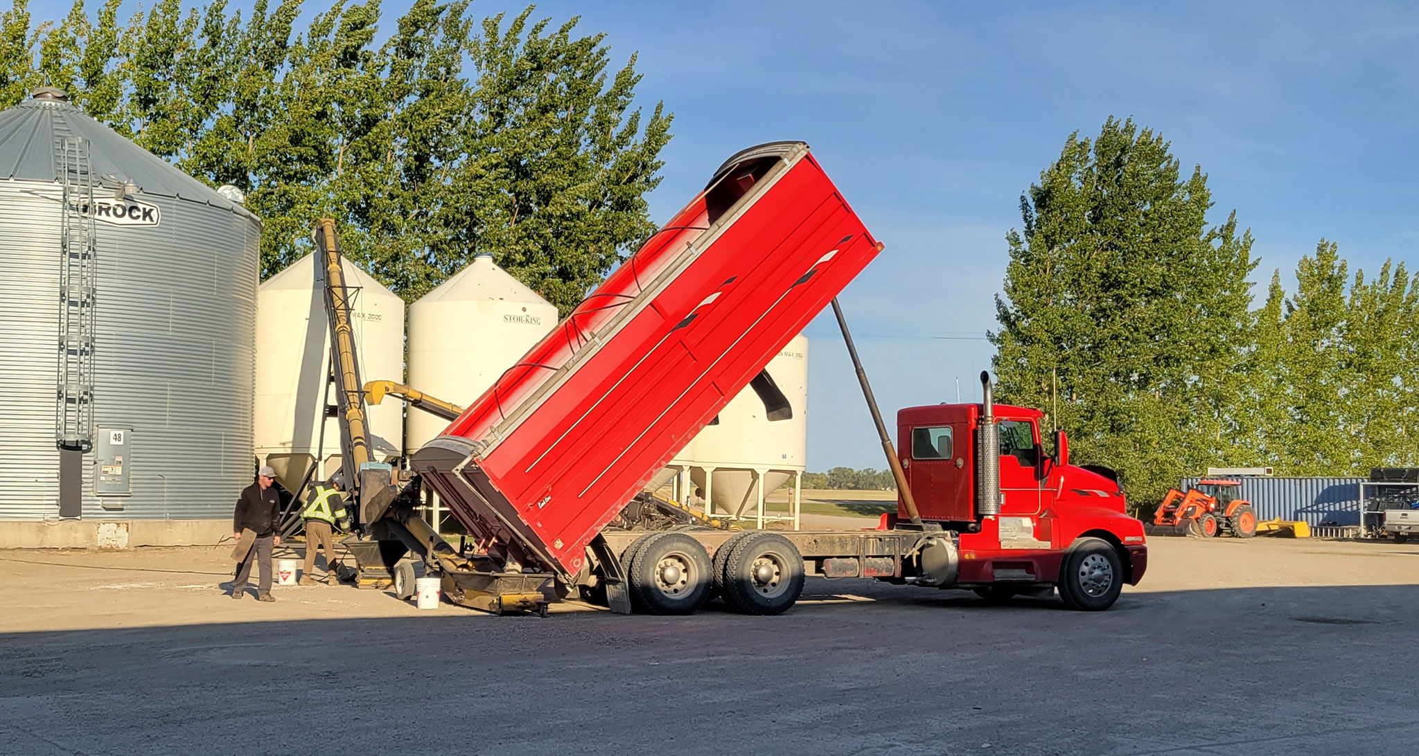 Photo of a truck at a receiving station unloading their beans.